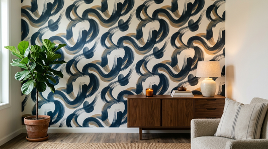 Editorial interior photograph of a living room corner where one accent wall is covered in printed abstract wallpaper with a